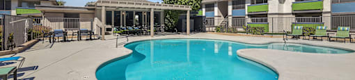 our apartments have a large swimming pool and a patio with chairs